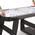 Children playing on a Air Hockey Table