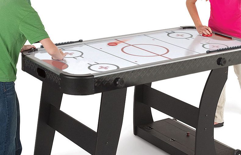 Children playing on a Air Hockey Table