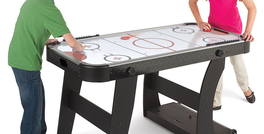 Children playing on a Air Hockey Table