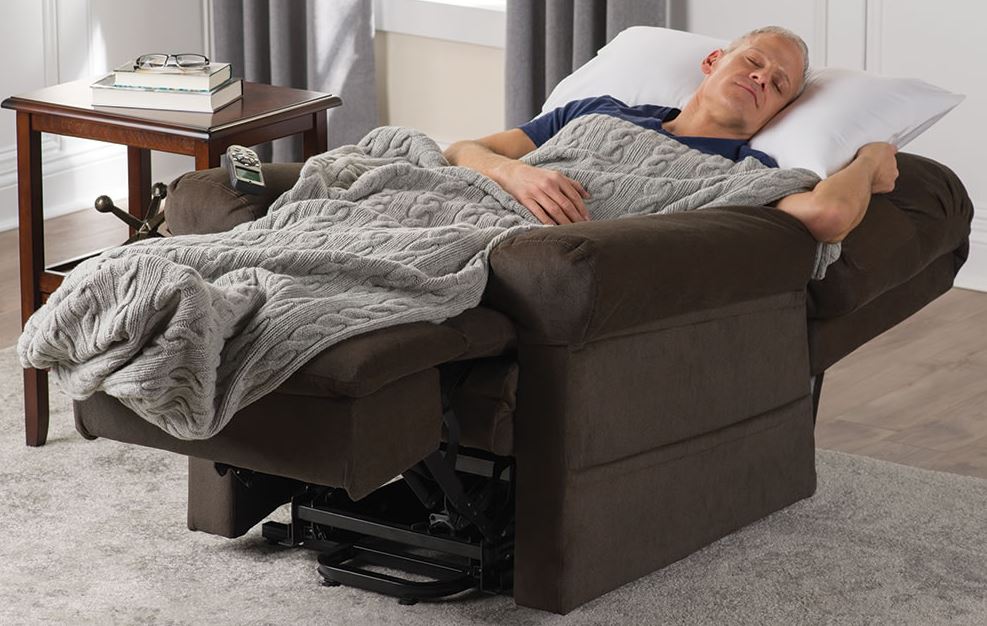 man sleeping in recliner in living room