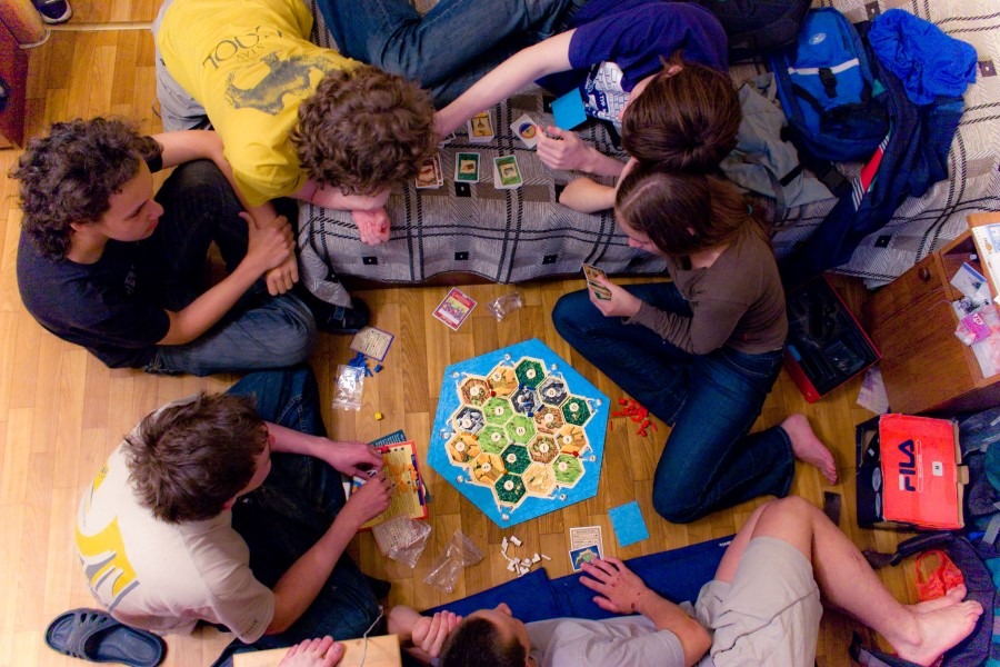 Friends Playing Settlers of Catan